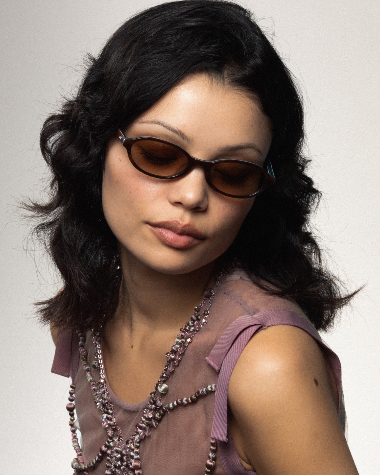 Two friends wearing statement sunglasses outdoors